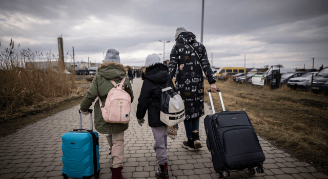 Refugees from Ukraine walk away from the conflict caused by the Russian invasion