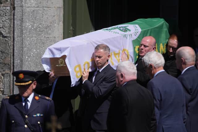 Inside the church, as the service began, members of the Garda’s Ceremonial Unit placed the Irish flag on Garda Flatley’s coffin, along with his cap and gloves.