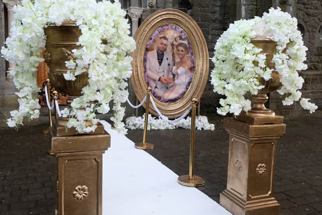 Outside the church, at the top of the 28 steps was a white carpet with garlands leading to the front door. Beside it was an eight-foot oval-shaped photo of Marguerita and Denis on their wedding day surrounded by gold embellishments.
