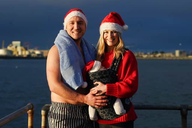 He said he was “delighted” to start a Christmas day tradition with Jill Owens and their 10-week old daughter Maisie – as all three wore Santa hats.