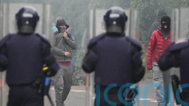 Violence flared as bricks were thrown at Gardai and the fire service and a bin was set alight.