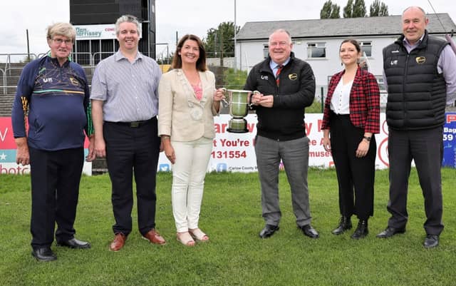 Jim Bolger, Chairperson of Cumann Luthchleas Gael Ceatharlach, handing over the recently retired Junior Hurling Championship Cup