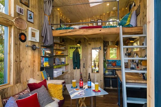 On entering the space through the double glass doors at the front, you will find a couch on the left and a tiny woodburning stove on the right which heats the treehouse. All fuel is provided.