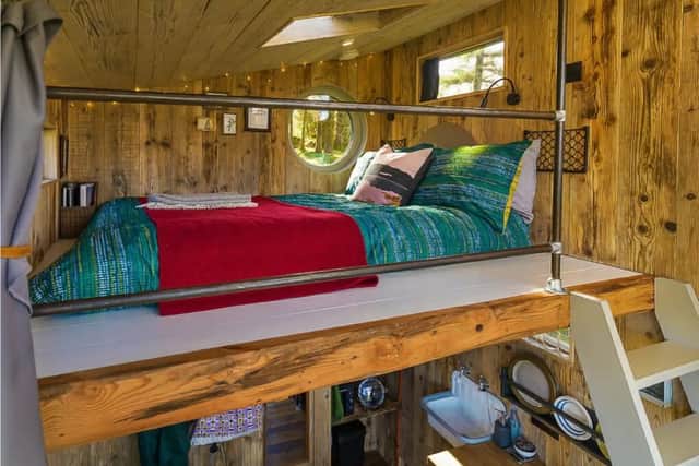 A mezzanine above the living space holds a standard double bed and is accessed by a small secured staircase on the right. Although you cannot stand upstairs, most people should be able to kneel comfortably.