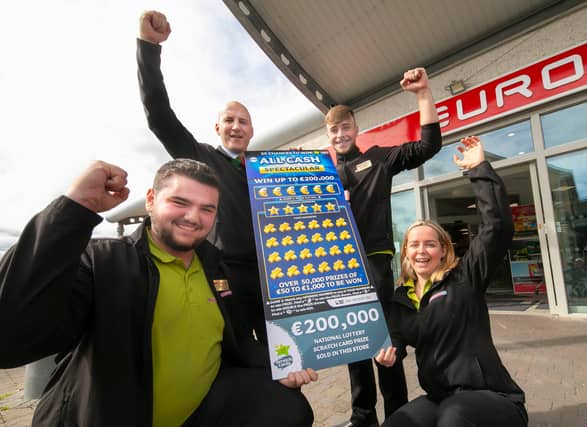 James McCarthy, manager of the McCarthy’s EuroSpar store in Newpark, Kilkenny celebrates with staff after they sell a winning €200,000 National Lottery All Cash Spectacular scratch card prize.