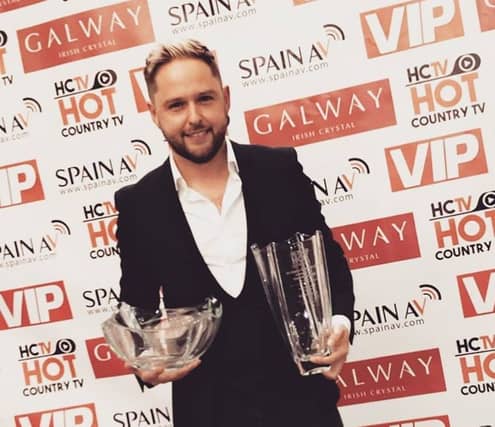 Derek Ryan with his awards