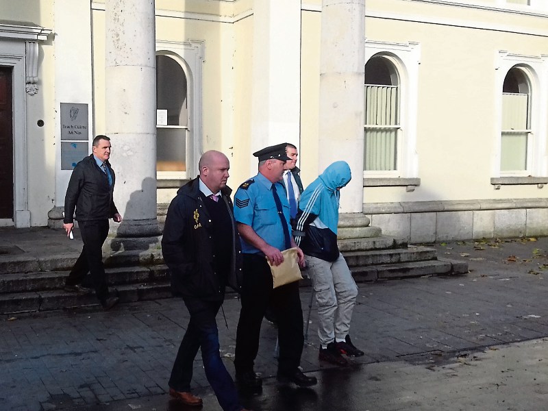 The defendant (crutches) leaves Naas Courthouse