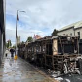 A burned-out Glider bus on Newtownards Road in east Belfast after anti-immigration violence