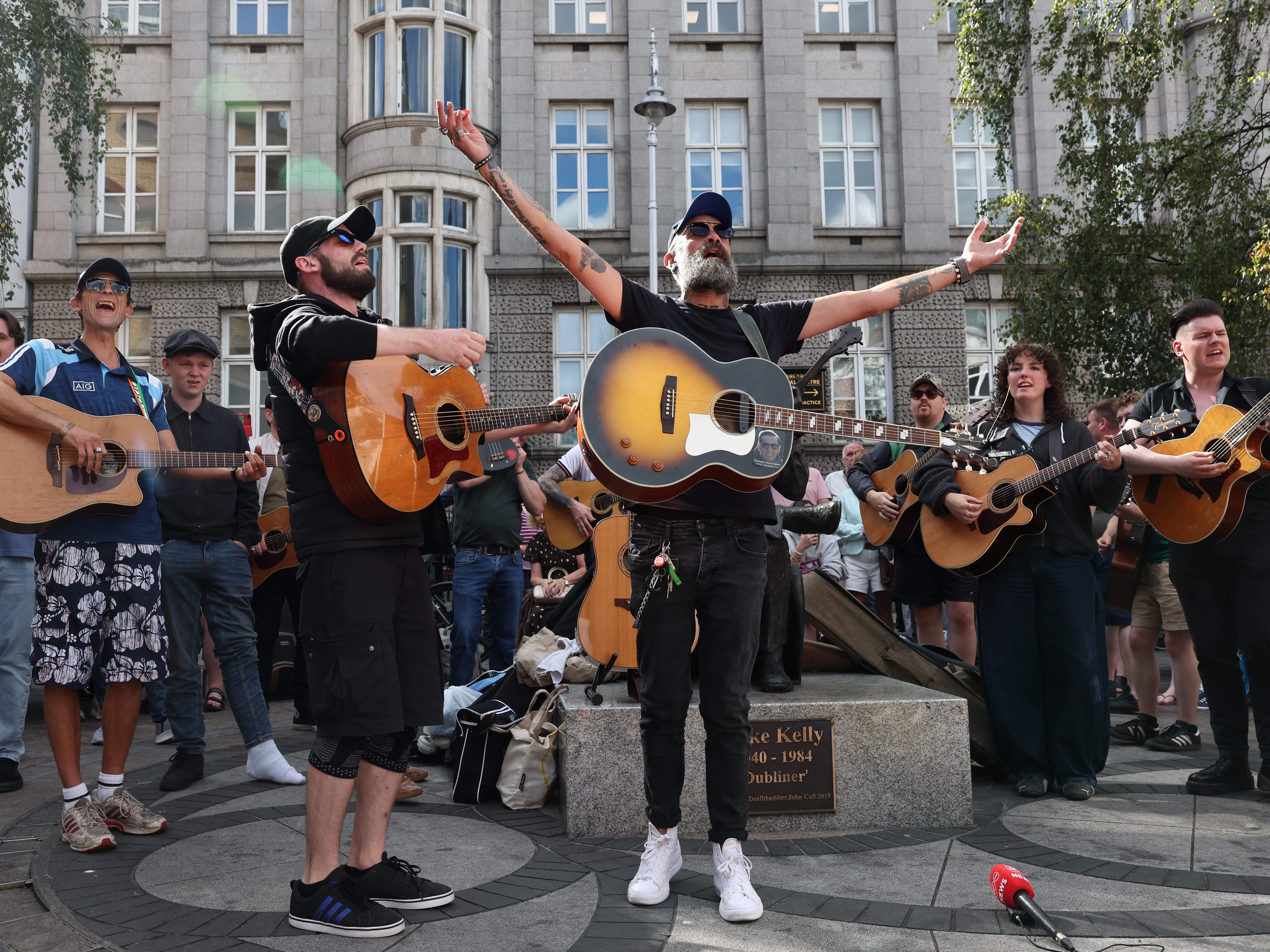 Musicians play in memory of Glen Hansard on King Street in Dublin