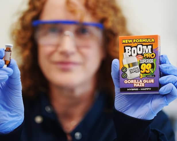 Sinead McNamara holding up a product wearing protective gloves