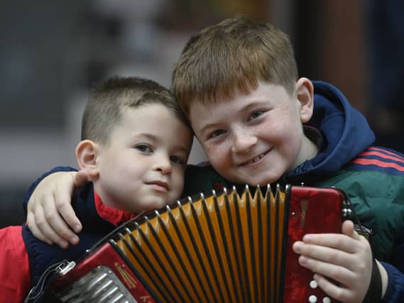 Two young boys with an accordion