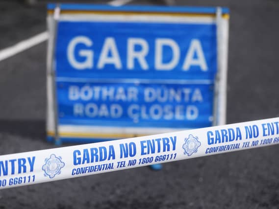 Garda tape and road closed sign