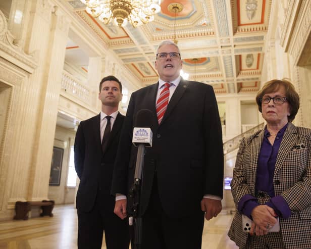 (left to right), DUP MLA Jonathan Buckley, party leader Gavin Robinson MP, speaking with media, and DUP MLA Diane Dodds in the Great Hall at Parliament Buildings, Stormont, after a plenary sitting of the Northern Ireland Assembly following a day-long stand-off over the Drumcree parade