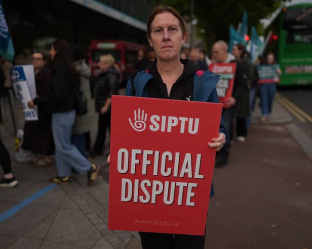 Sinead McCarville, senior housekeeper in the high dependency unit at the Mater Hospital, Dublin, takes part in a 24-hour strike outside the hospital over delays in agreeing a new public sector pay deal