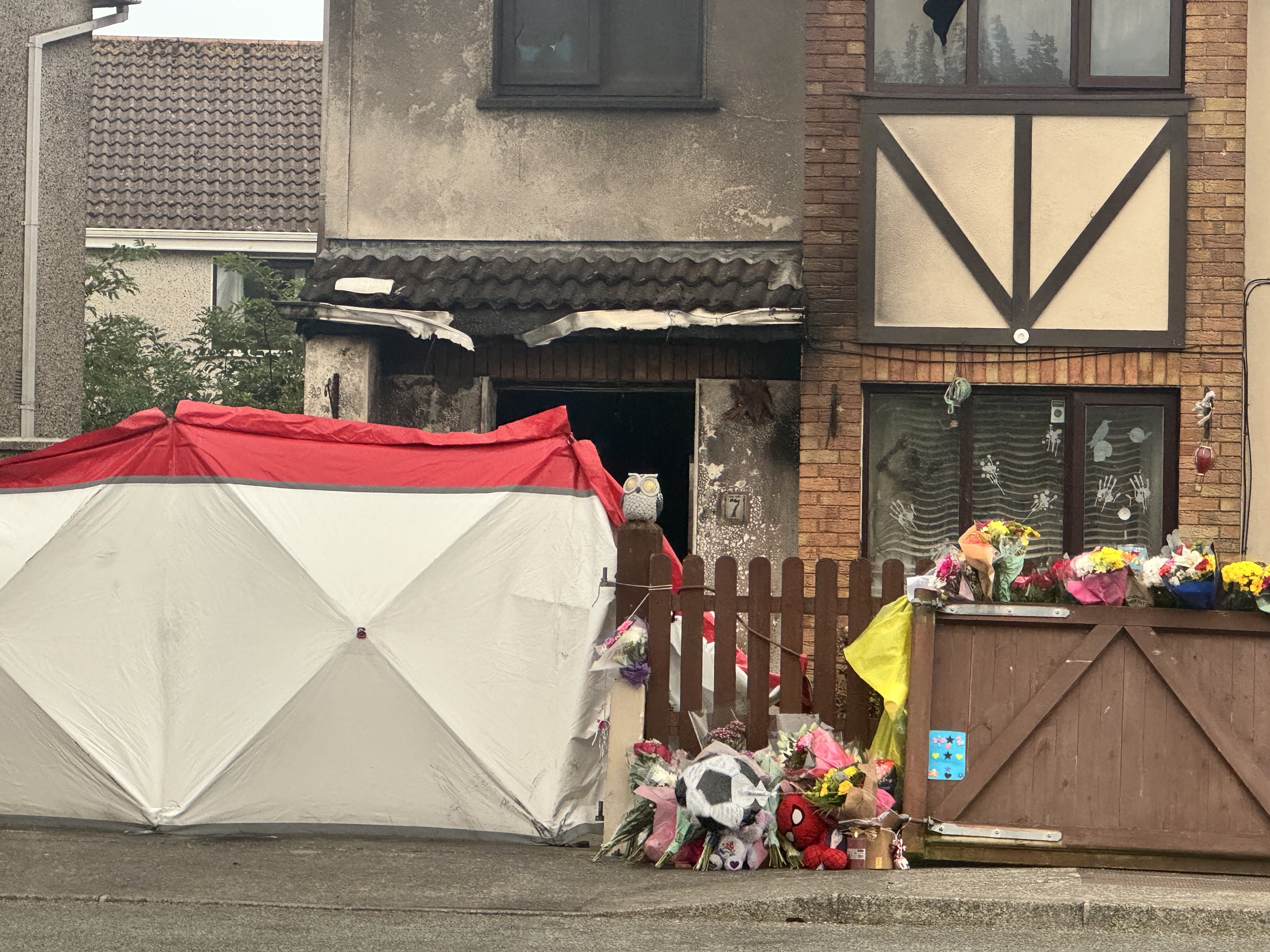 Floral tributes outside the scene of the house fire
