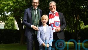 Dublin boy treated for rare illness presents premiers with football shirts