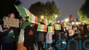 Protesters let off pink smoke during asylum demonstration at Citywest