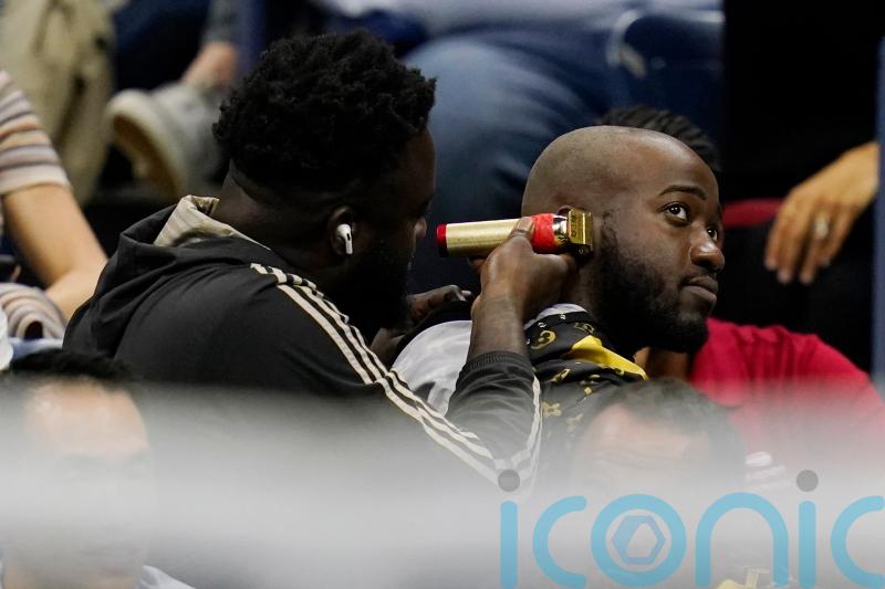 Fans removed from sports event for having a haircut in the stands